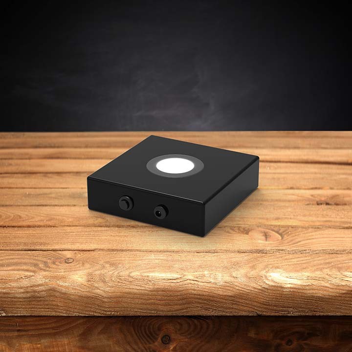 Wood LED light base with a dark background
